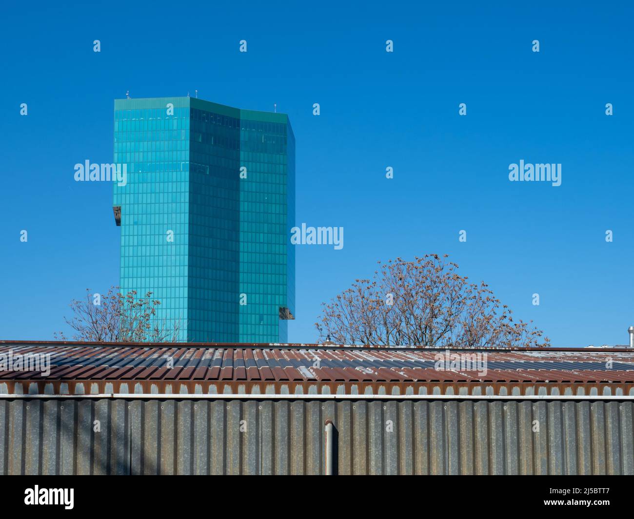 Zurich, Switzerland - March 5th 2022: The famous Prime Tower in front of a corrugated metal building Stock Photo