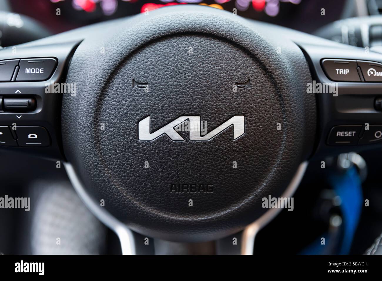 Stade, Germany –January 7, 2022: New KIA brand logo on steering wheel of compact car manufactured by the South Korean company. Stock Photo