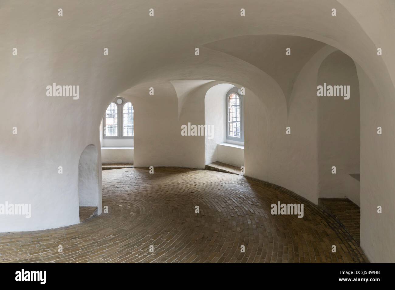 Interior of the 17th century Round Tower or Rundetaarn in Copenhagen, Denmark. Sloping spiral walkway formerly used by horse-drawn wagons. Stock Photo