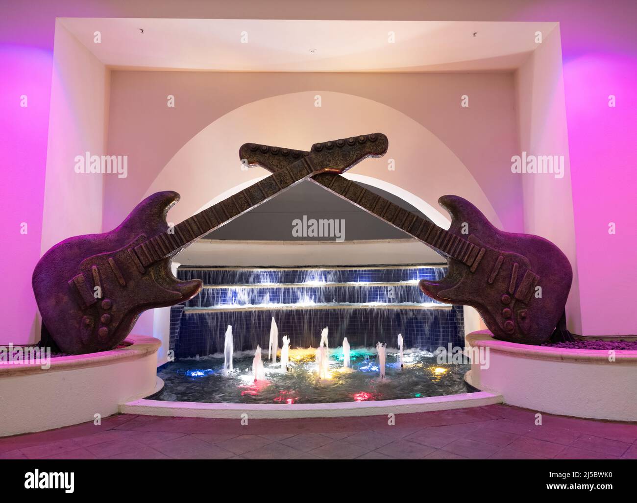 guitar sculpture decor with illuminated fountain water Stock Photo Alamy