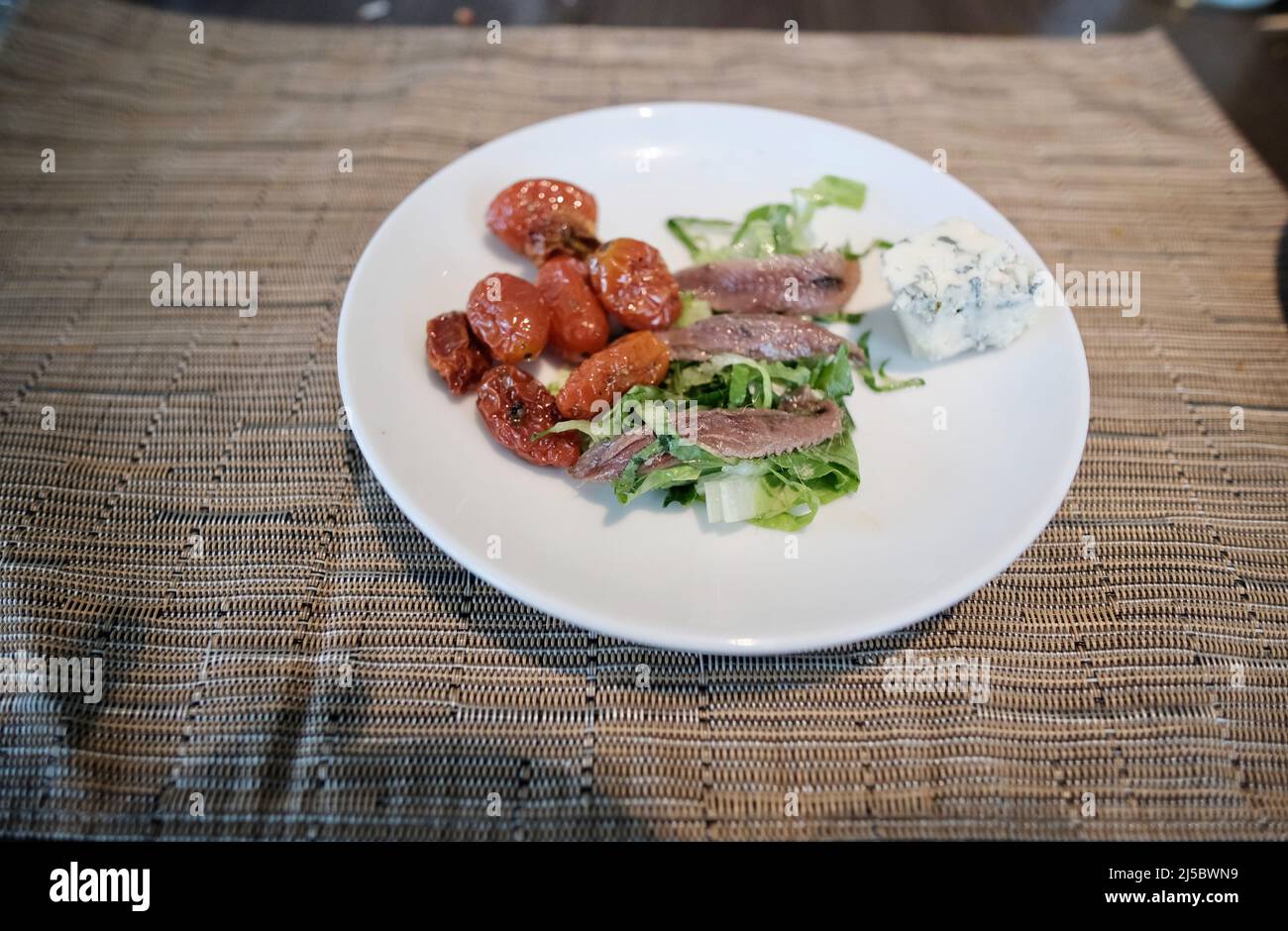 Ceasar salad plate with blue cheese and cherry tomatoes romaine lettuce anchovies Stock Photo