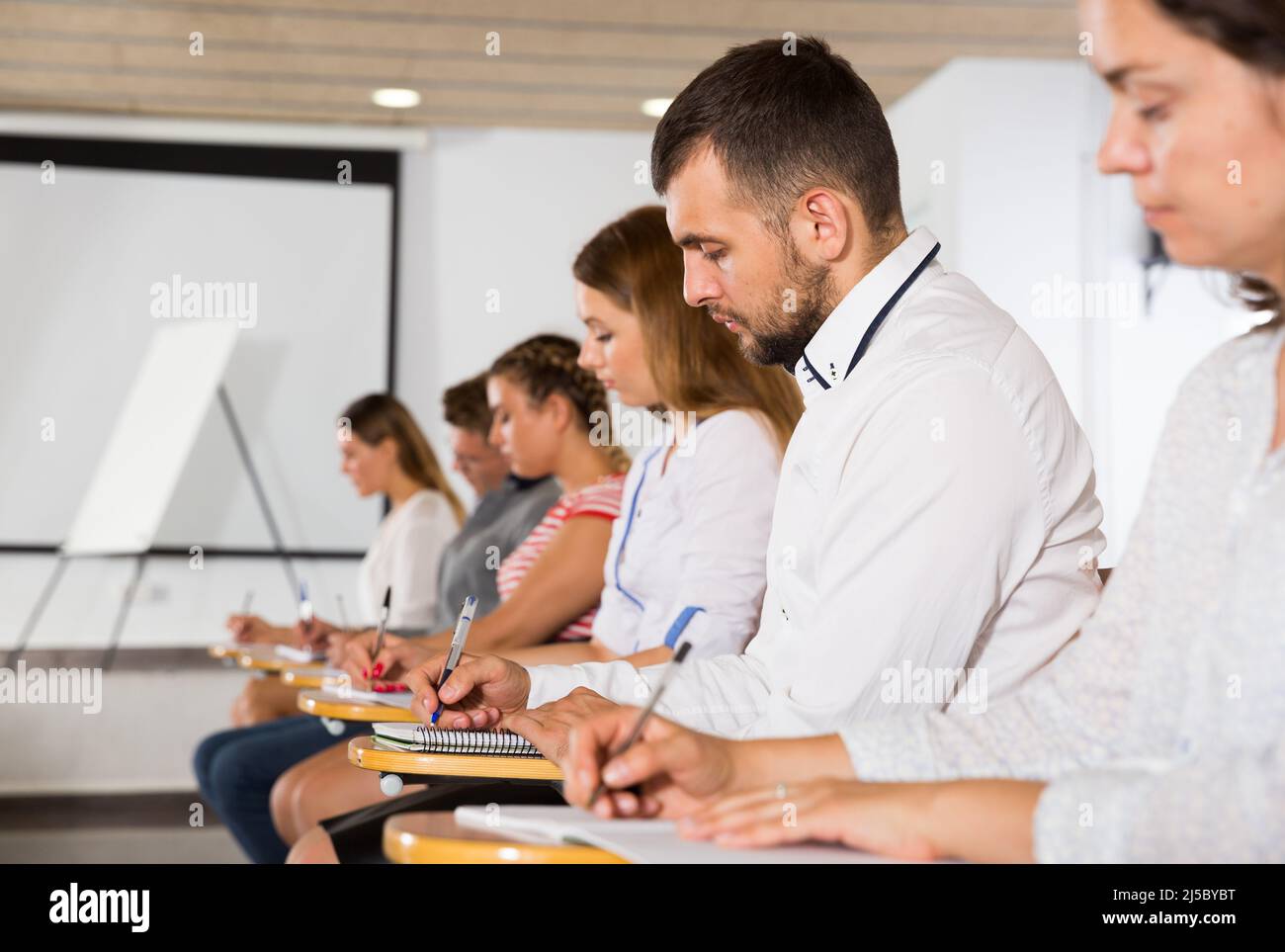Auditorium. View Side view of young people in auditorium Stock Photo - Alamy