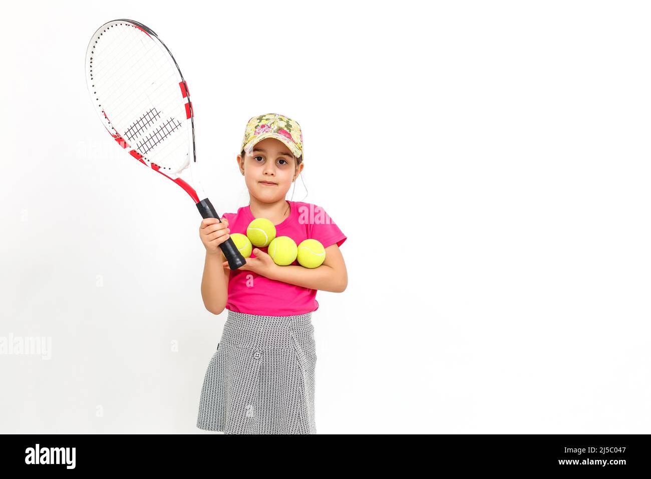Little Tennis Rackets Cute little girl with tennis racket in her hands on white background ...