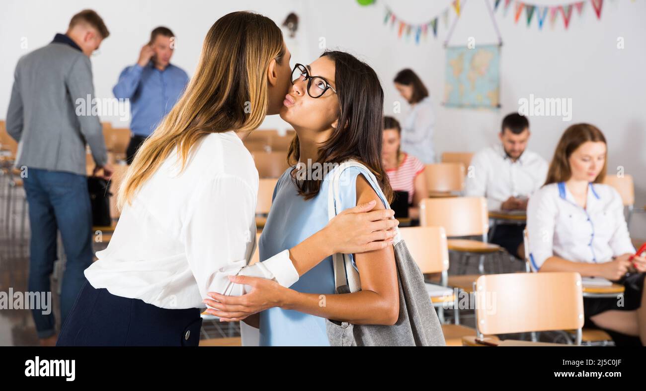 Two females kissing each other by meeting Stock Photo