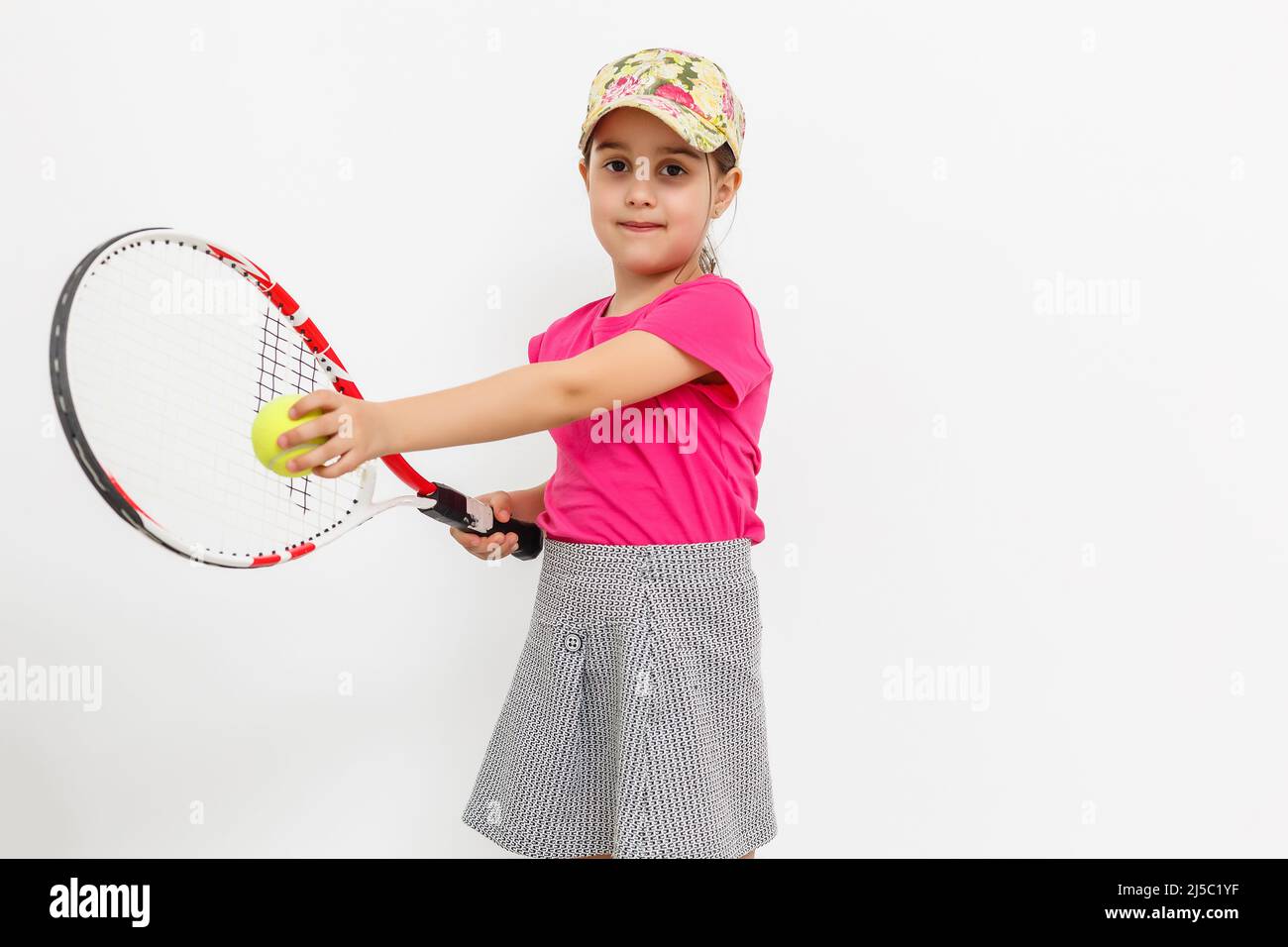 Little Tennis Rackets Brunette little girl with a tennis racket isolated on a over white ...