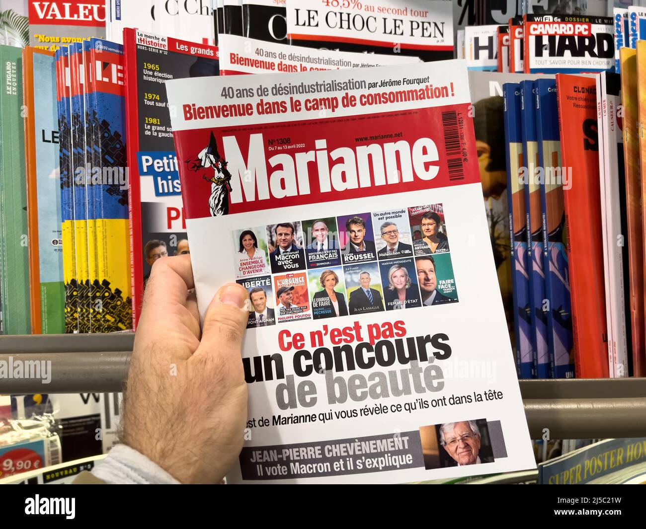 Paris, France - Apr 11, 2022: Stand with Marianne newspaper magazine covering the French presidential election of 2022, Macron, Melenchon, Le pen, Zemmour, Hidalgo, Pecresse, Jadot, Putou, Roussel Stock Photo