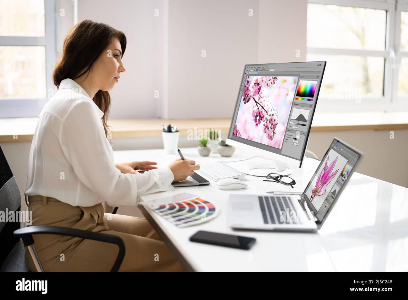 Graphic Designer Artist Working On Multiple Computer Screens Stock