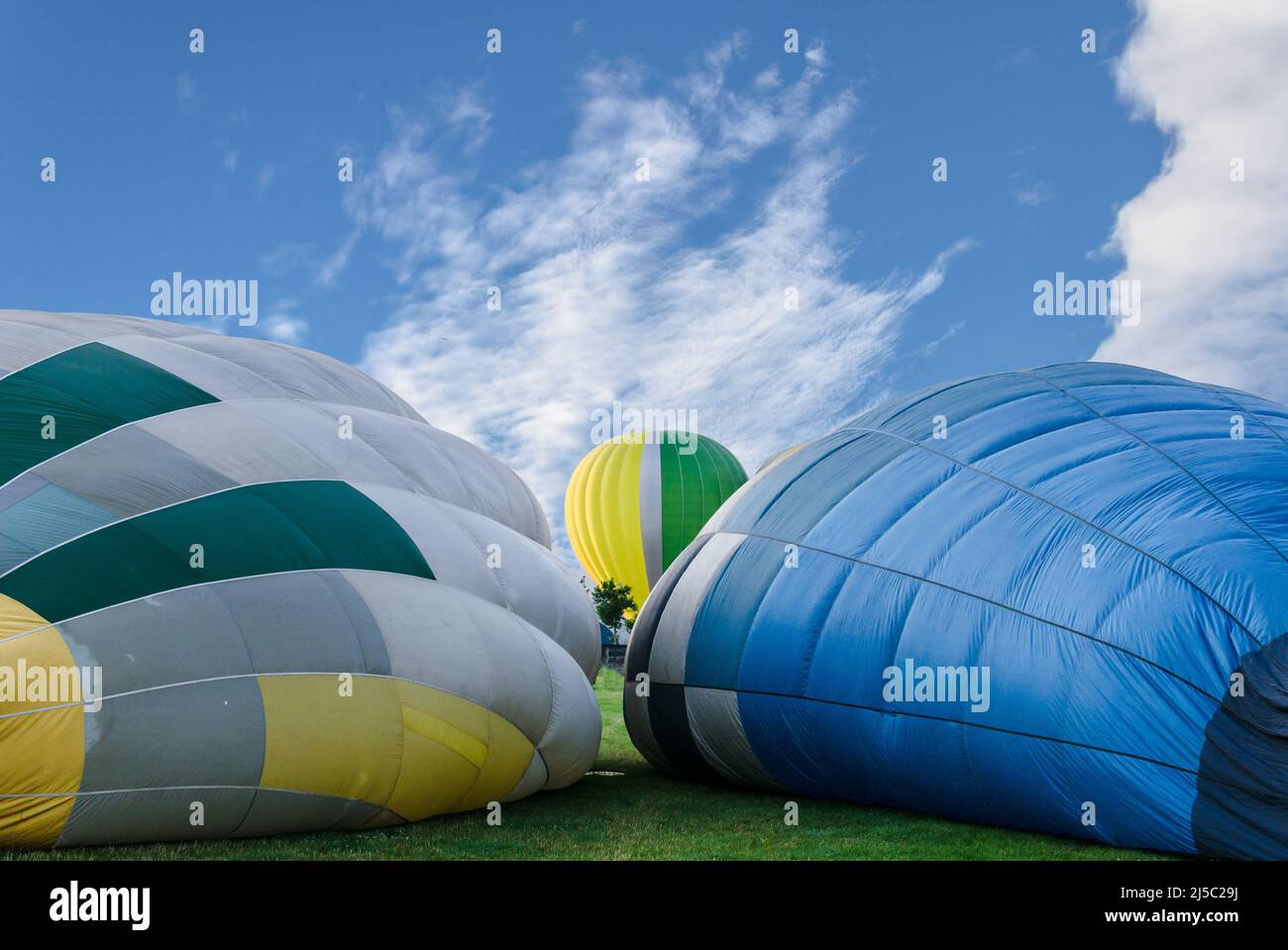Colorful hot air balloon flying over blue sky Stock Photo - Alamy