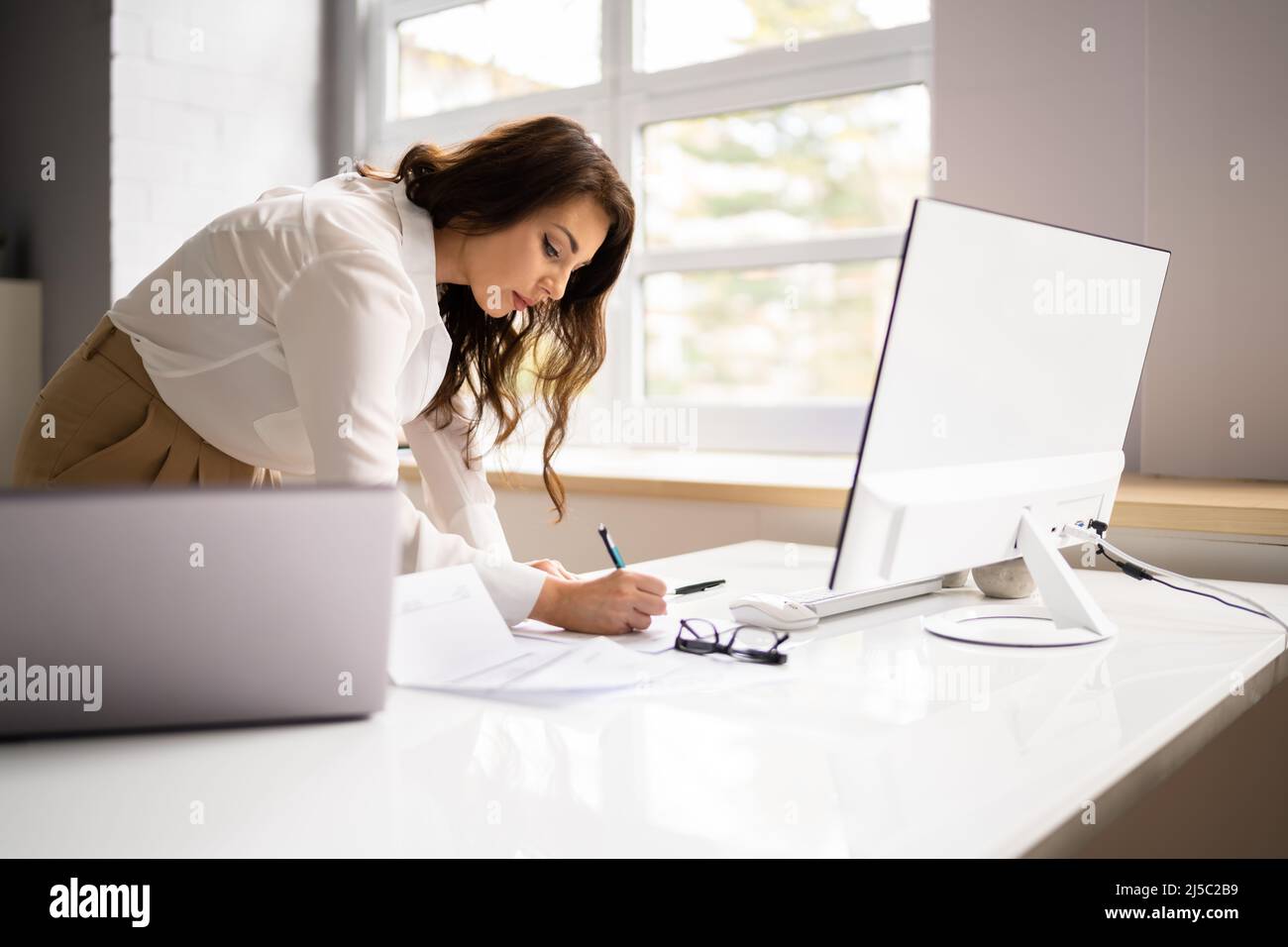 Accountant Woman Using Office Computer To Calculate Invoice Stock Photo ...