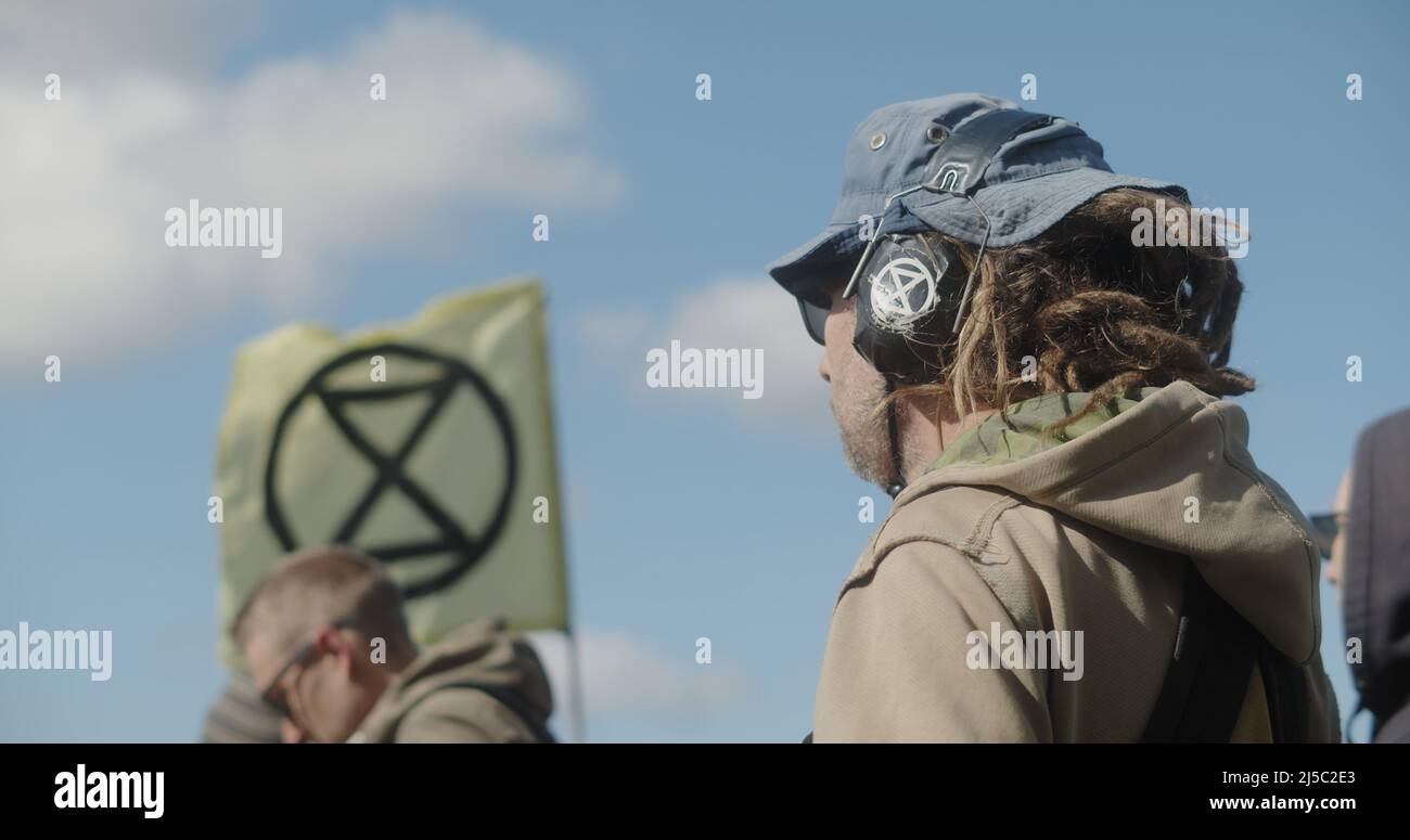 London, UK - 04 09 2022: A CLOSE UP of male climate protester playing a ...