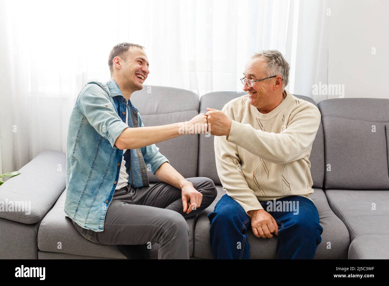Hipster son with his senior father at home Stock Photo - Alamy