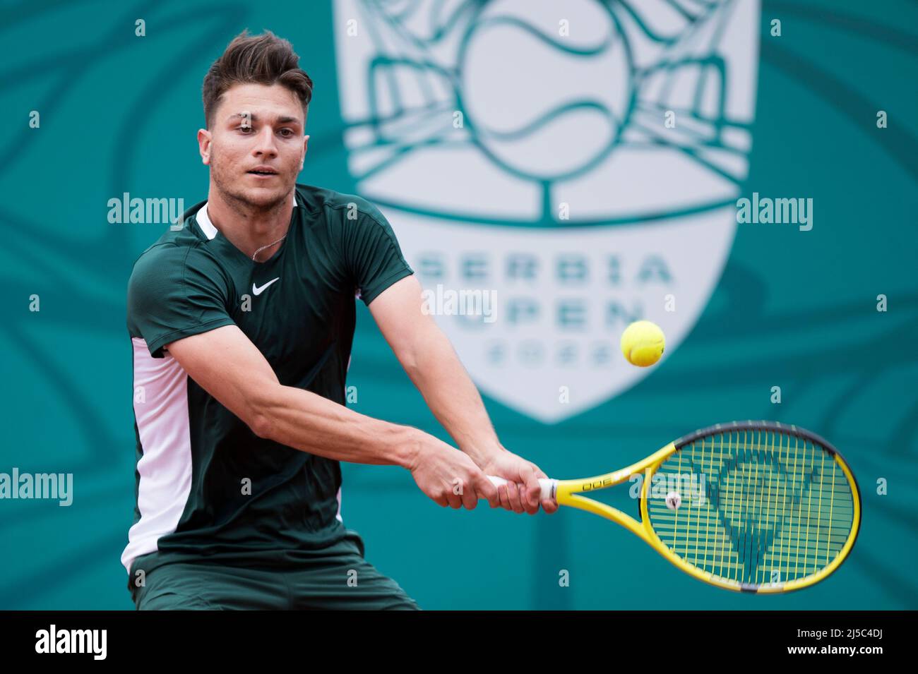 Belgrade, Serbia, 20th April 2022. Miomir Kecmanovic of Serbia returns  against John Millman of Australia during during the day three of Serbia  Open ATP 250 Tournament at Novak Tennis Centre in Belgrade,