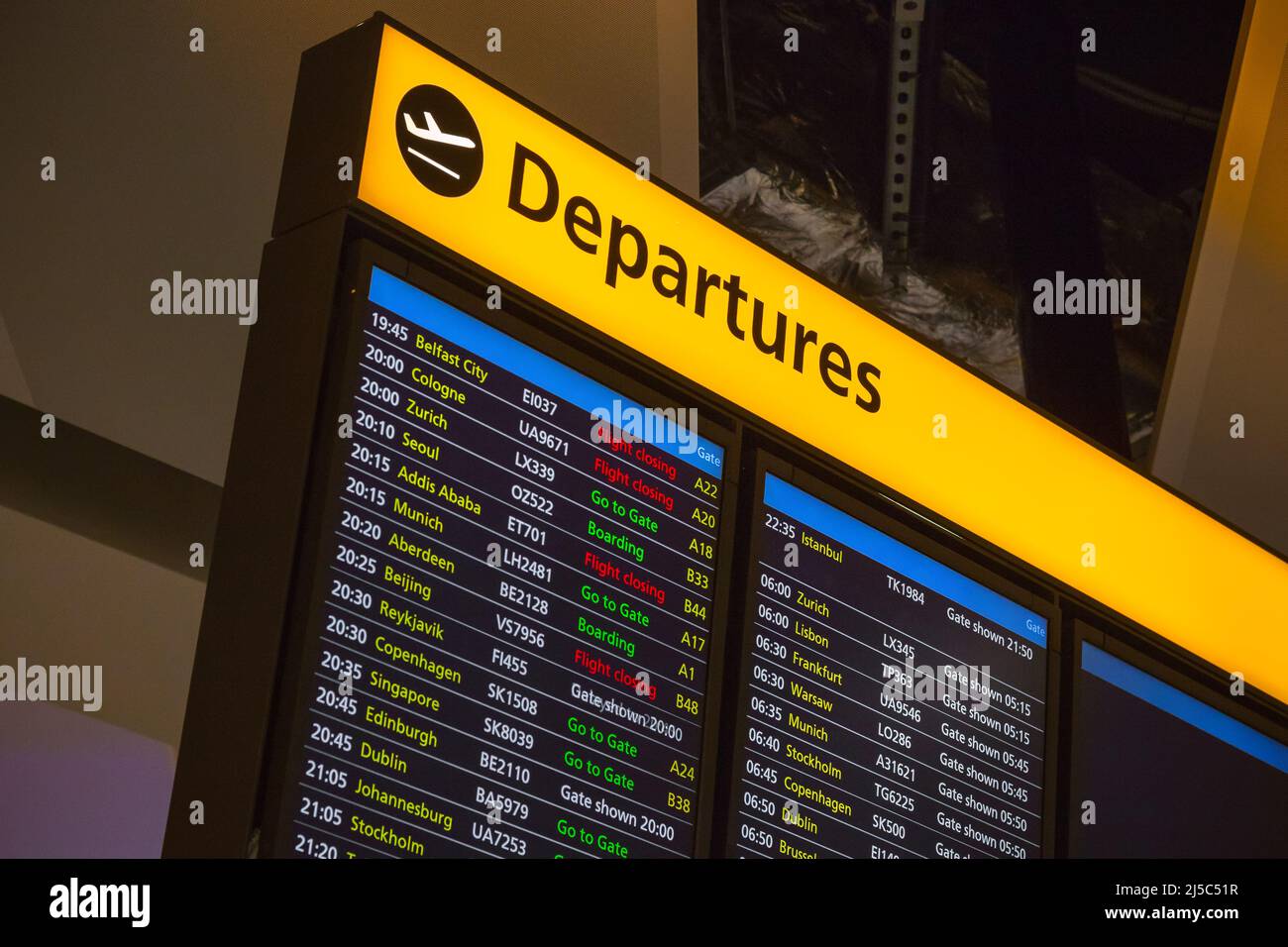 Departure board displaying time, destination cities and gate information in London Heathrow airport Stock Photo