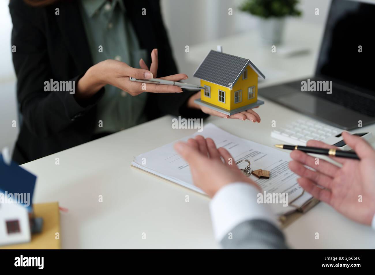 Real estate agent offered home sales and explained the terms of signing the house purchase contract and free home insurance, Finance and after-sales Stock Photo
