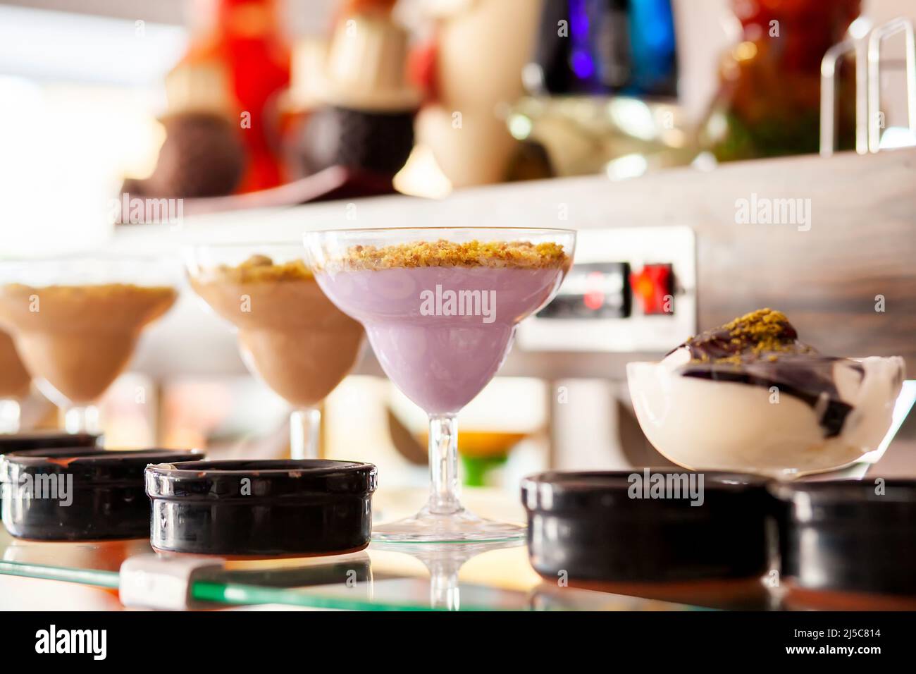Creamy pudding in cocktail glasses. Dessert table in a Turkish hotel