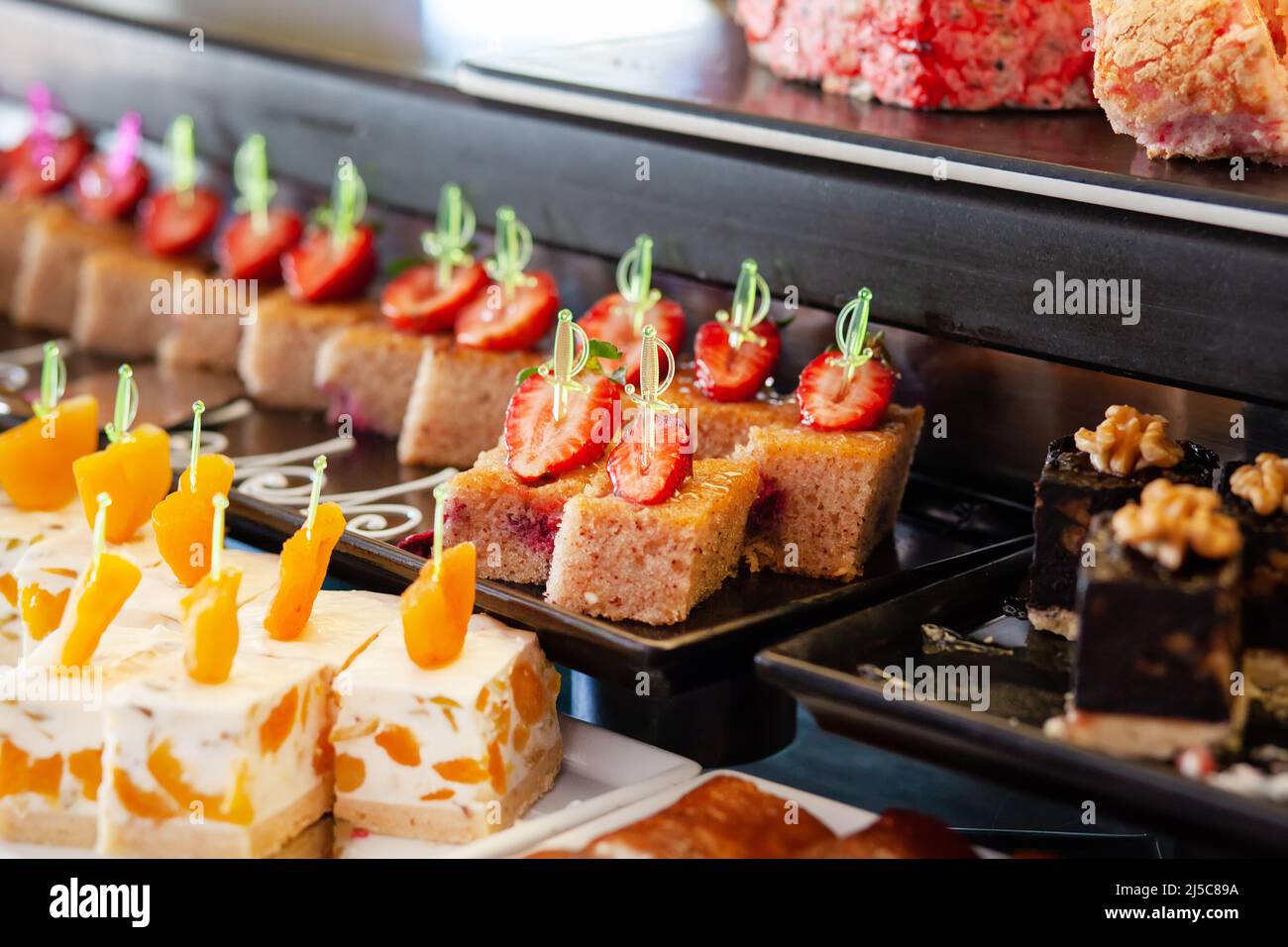 Biscuit with strawberries. Dessert table in a Turkish hotel. Various cakes and sweets on buffet