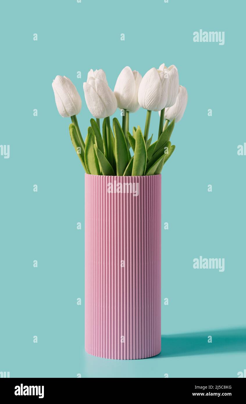 Retro vase with tulip flowers on a mint background. Summer, spring minimal concept. Stock Photo