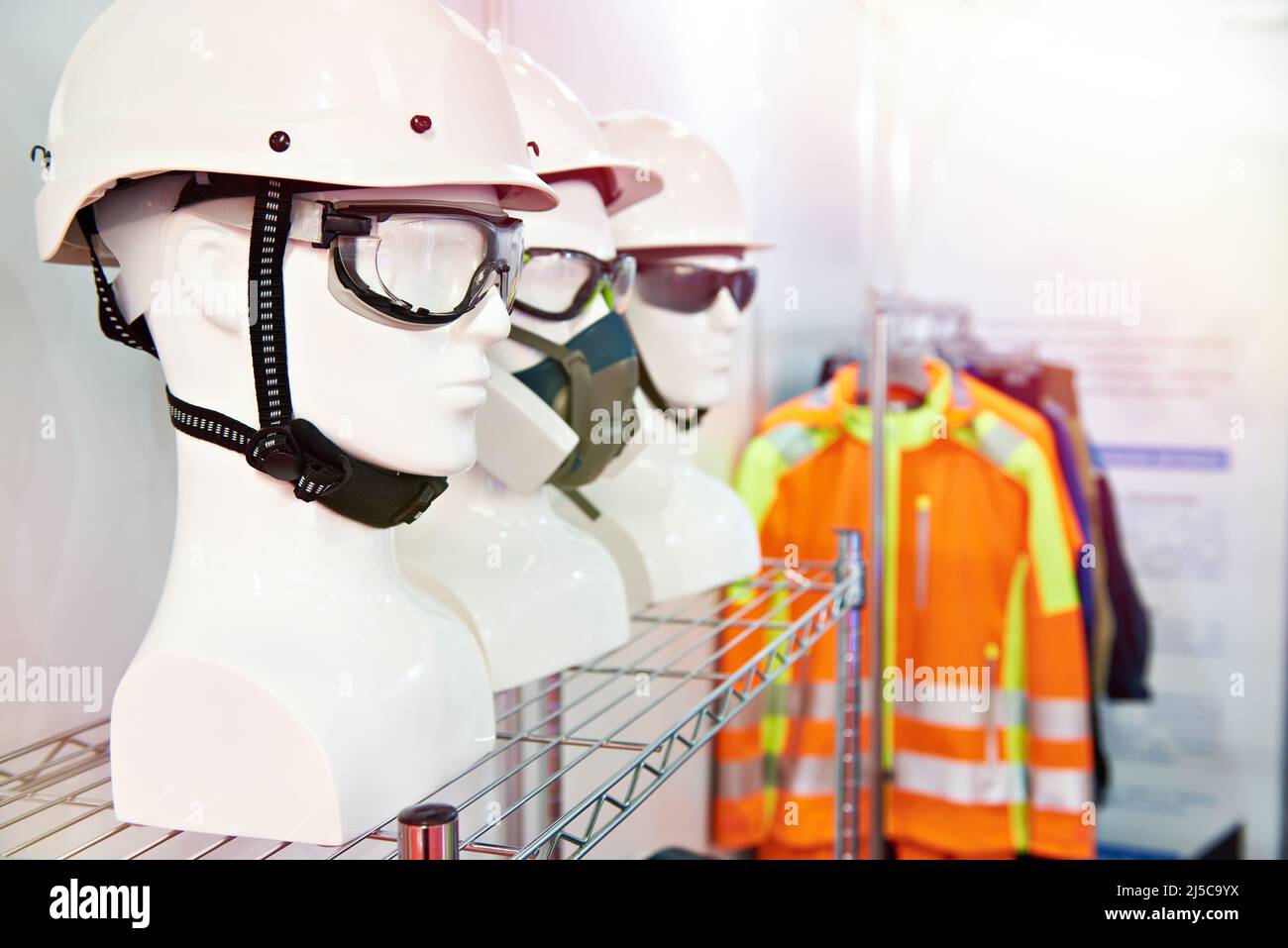 Protective helmets and goggles in a work clothing store Stock Photo