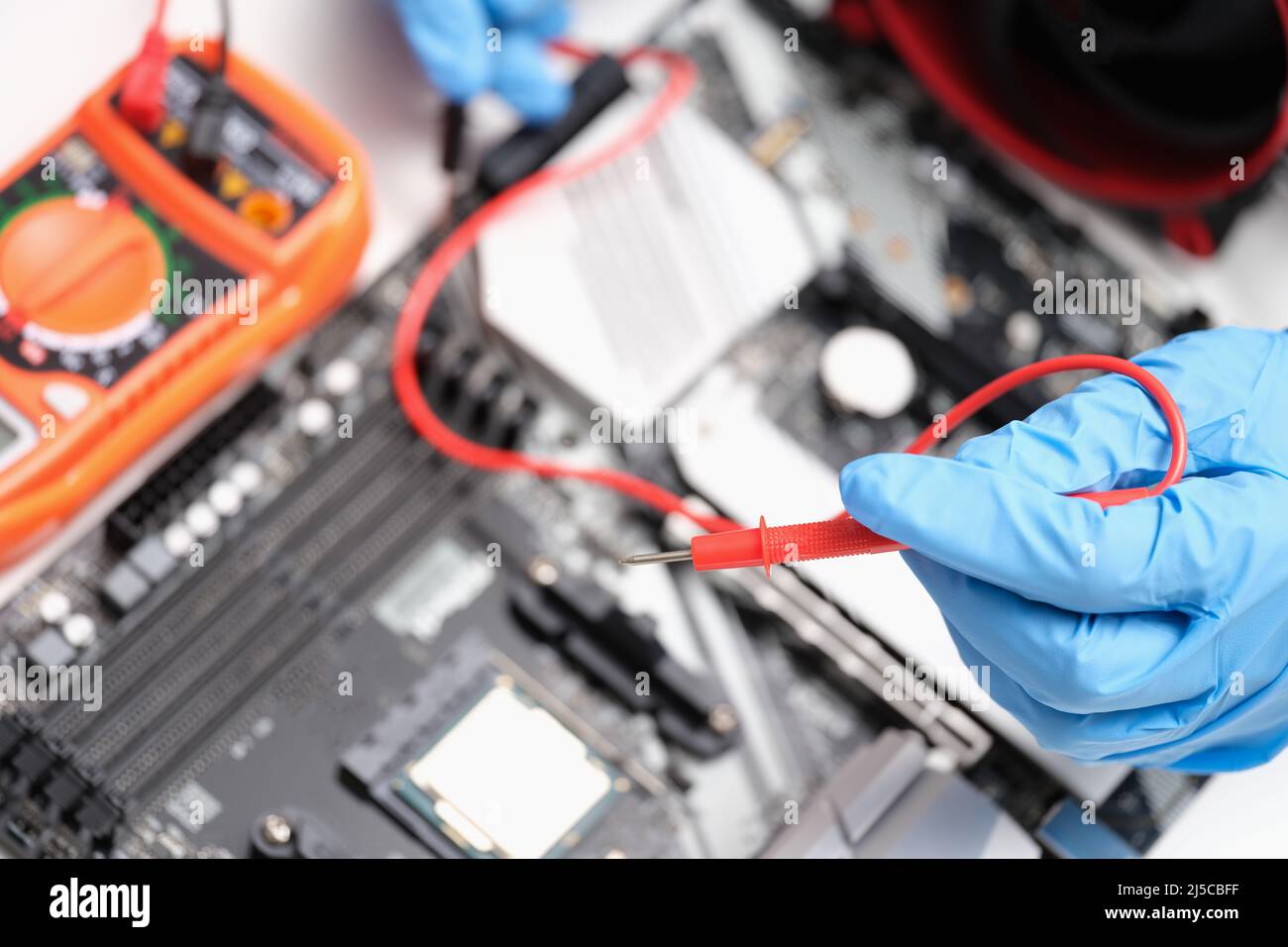 Engineer is testing motherboard chip repair closeup Stock Photo