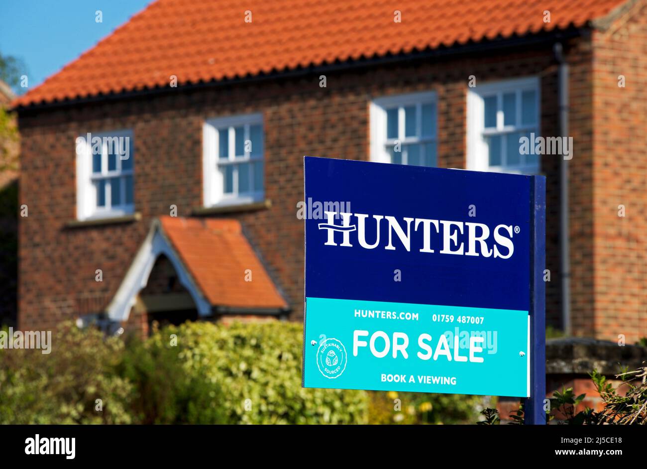 House for sale sign, erected by Hunters estate agents, Yorkshire, England UK Stock Photo