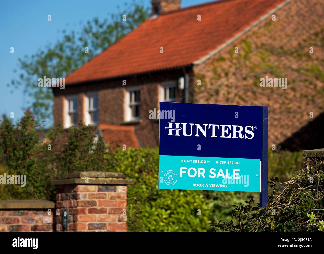 House for sale sign, erected by Hunters estate agents, Yorkshire, England UK Stock Photo