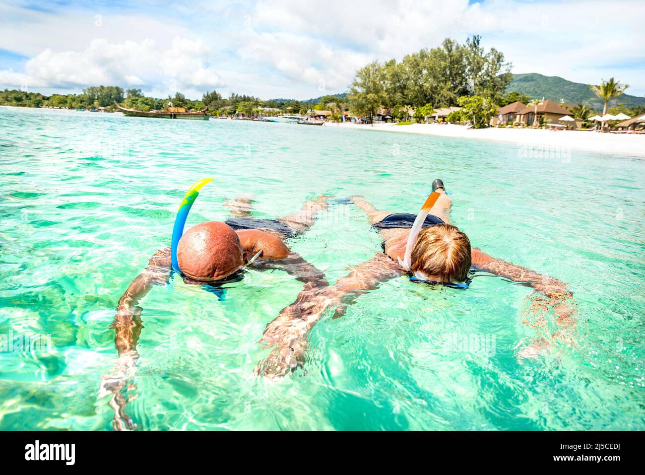 Senior couple vacationer swimming together on tropical Koh Lipe sea in