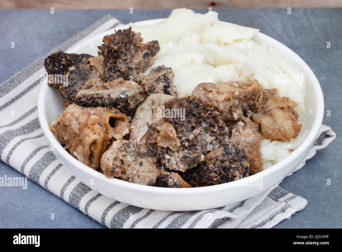 Mogodu, a Traditional South African stew made of chopped innards of a cow or tripe served with pap or maize meal. Stock Photo