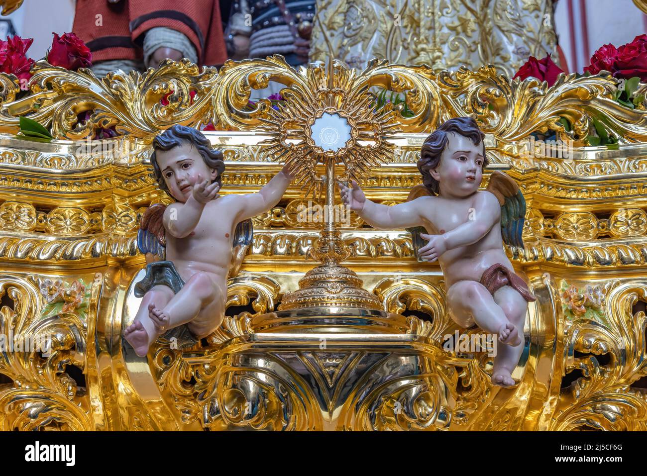 Golden Custodian Ostiary guarded by two angels on the front of a paso (Platform or throne) of Holy Week Stock Photo