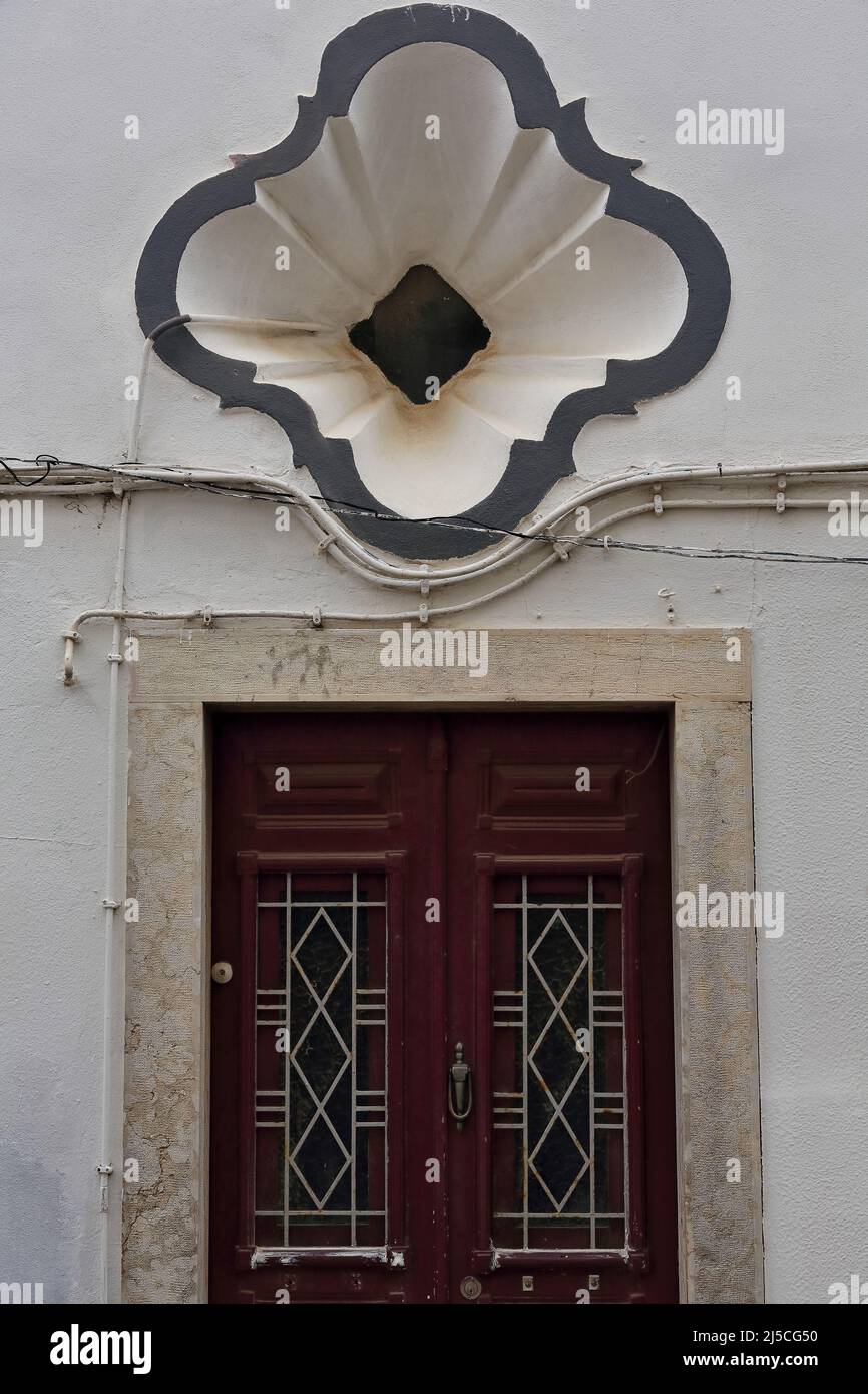 Metal meshwork panel door-townhouse facade-flaring niche-Rua Primeiro Maio Street. Lagos-Portugal-216 Stock Photo
