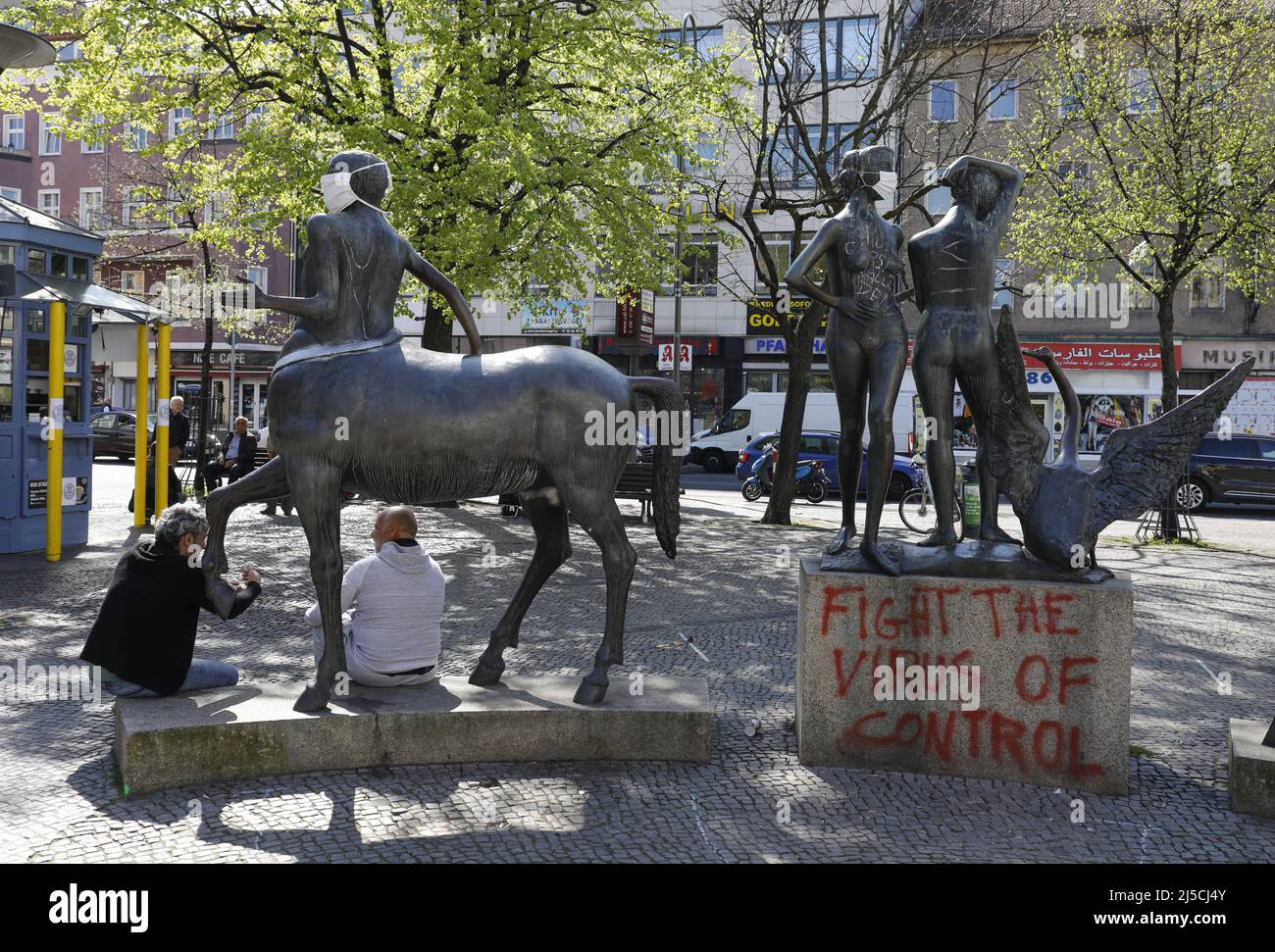 'Unknown persons have put mouth guards on a group of figures titled ''Linda with Swan, Cyclops and Centaur'' at Berlin's Karl-Marx-Platz and spray-painted it with the phrase ''Fight the Virus of Control''. The contact ban in force because of the Corona pandemic has been extended for a few weeks. [automated translation]' Stock Photo