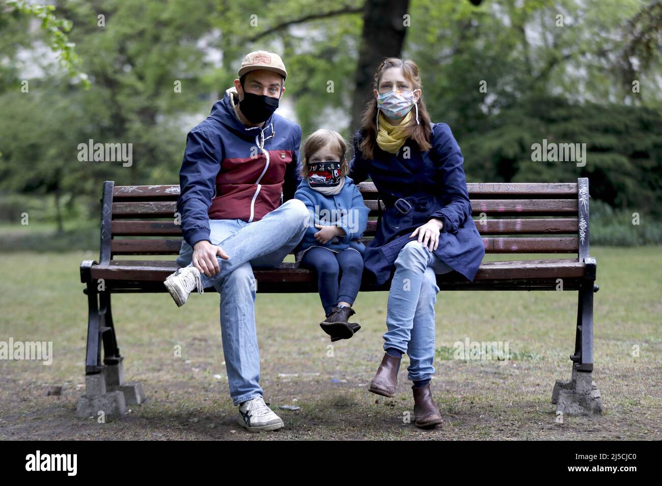 Portrait photo of a family with face masks in a park in Berlin. [automated translation] Stock Photo