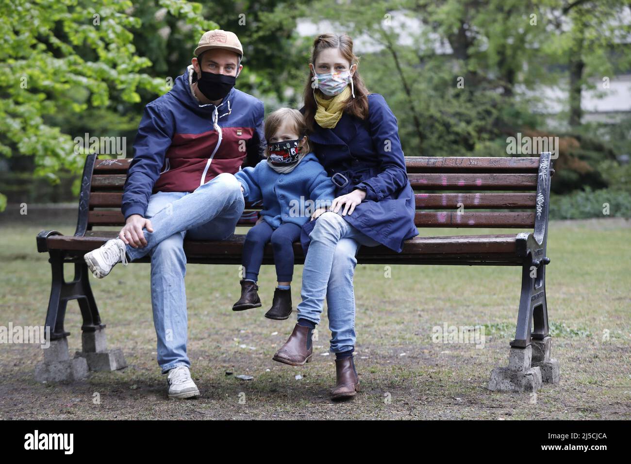 Portrait photo of a family with face masks in a park in Berlin