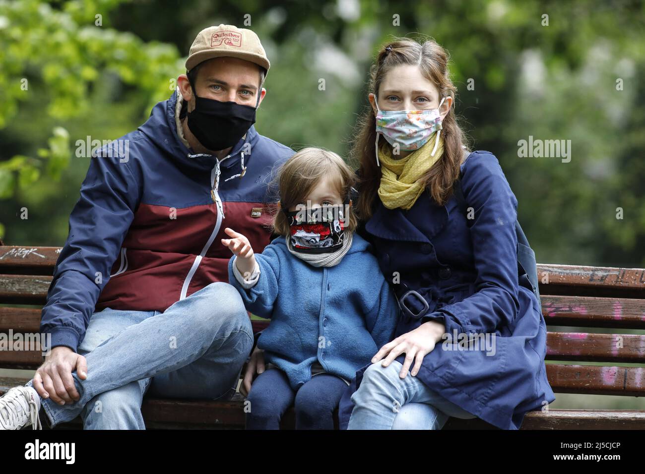 Portrait photo of a family with face masks in a park in Berlin