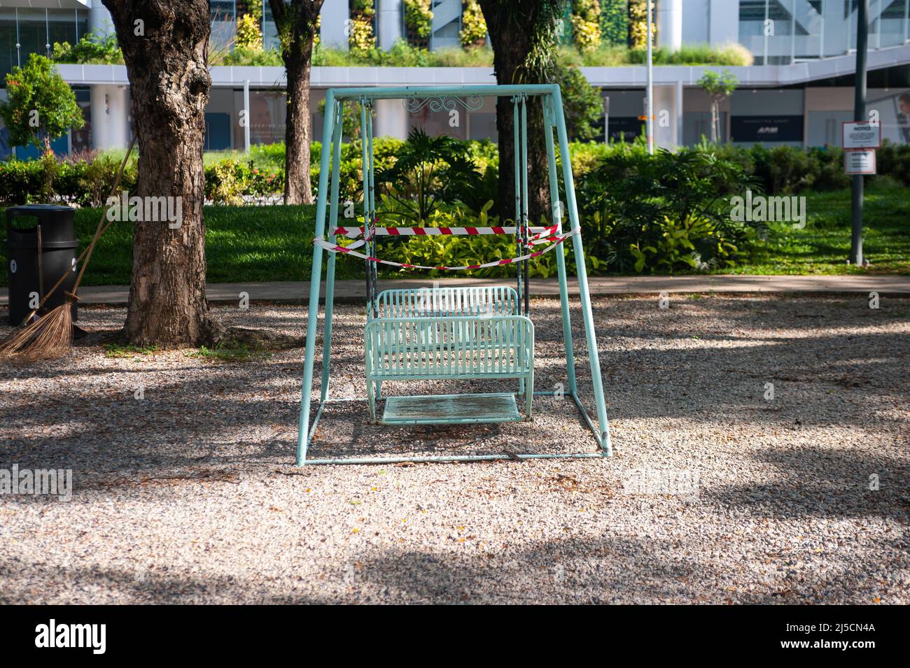 May 28, 2020, Singapore, Republic of Singapore, Asia - A swing set in a small park in Dhoby Ghaut has been cordoned off with red and white barrier tape during curfews amid the Corona crisis to halt the spread of the pandemic coronavirus (Covid-19). Other precautionary measures were introduced in public life, such as the closure of all non-essential shops and retailers, as well as all schools until June 1. [automated translation] Stock Photo