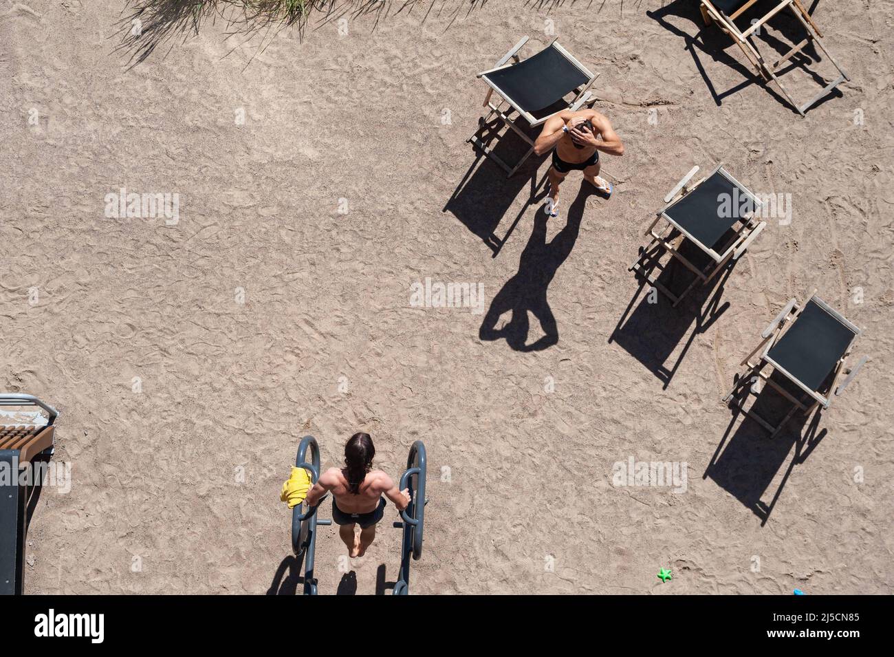 Jun. 23, 2018, Helsinki, Finland, Europe - Two men exercise on a warm summer day with their upper bodies exposed on a municipal public fitness track in the Finnish capital. [automated translation] Stock Photo