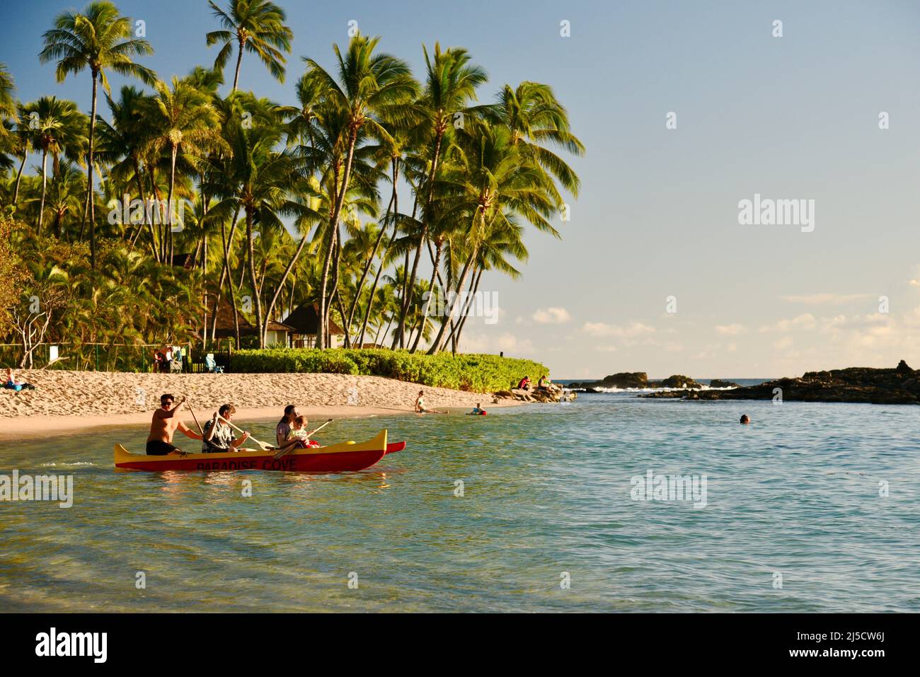 Guests paddling to going on Hawaiian outrigger canoe sunset ride as a
