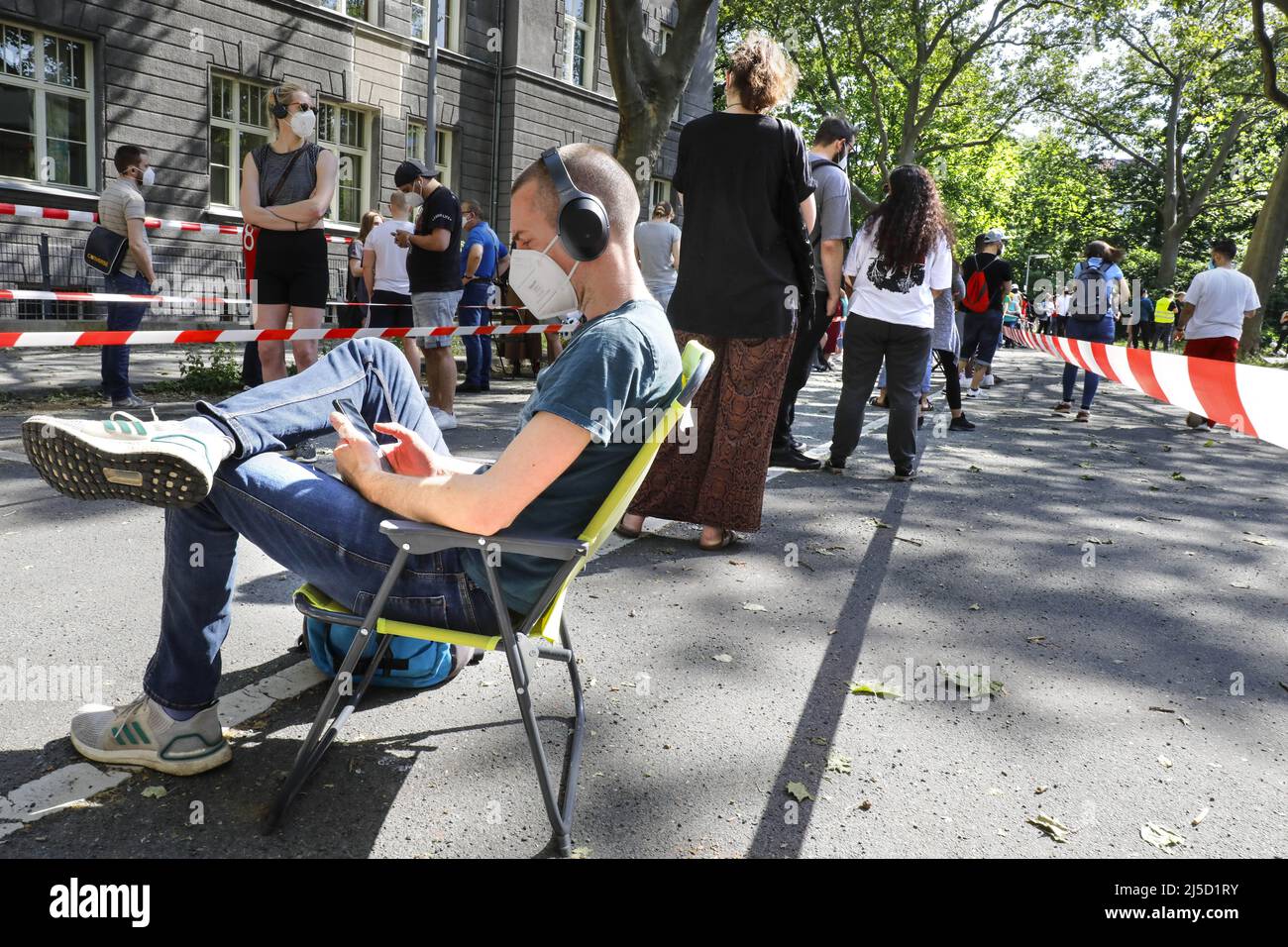 Berlin, 05.06.2021 - A vaccinated person sits on his folding chair in a long queue at the Prignitz School. In a focus vaccination can Kiezbewohner in the district Tempelhof Schoeneberg free of charge and without registration here. [automated translation] Stock Photo