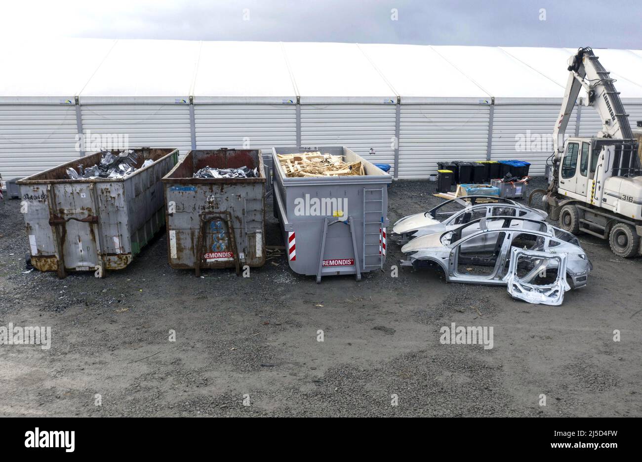 Gruenheide, Dec. 19, 2021 - 2 Tesla Y scrap chassis and scrap parts from the press shop in containers are seen at the Gigafactory construction site in Gruenheide. According to Tesla, production is to start soon. [automated translation] Stock Photo
