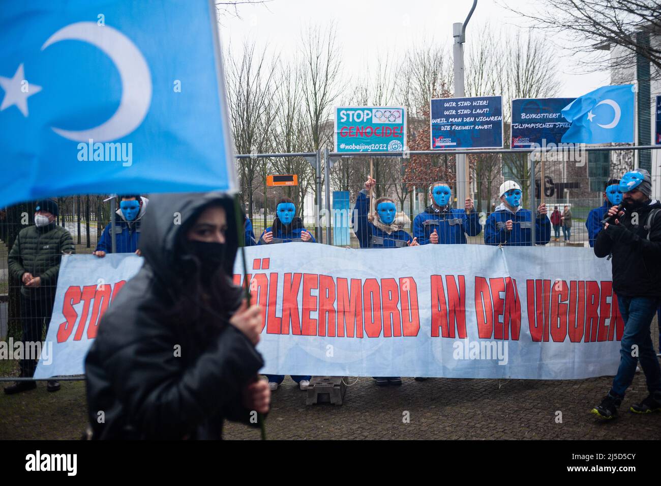 Jan. 29, 2022, Berlin, Germany, Europe - Masked demonstrators from the activist group The Young Righteous with banners, protest posters and flags protest the genocide of Uyghurs in the Chinese autonomous region of Xinjiang and respect for human rights and call for a diplomatic boycott of the 2022 Winter Olympics in Beijing at a rally in front of the Federal Chancellery in the Berlin-Mitte district. [automated translation] Stock Photo