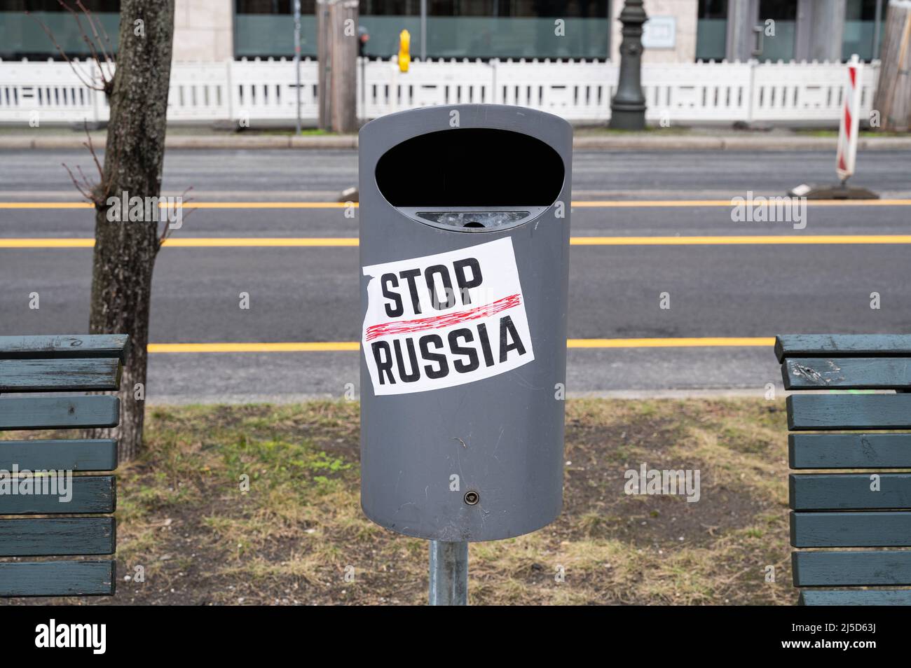 Feb. 26, 2022, Berlin, Germany, Europe - A sticker with the words Stop Russia is stuck to a trash can between two benches in front of the Russian embassy Unter den Linden in the Mitte district and is directed against the policies of Russian President Putin and the war in Ukraine after the invasion of Russian soldiers. [automated translation] Stock Photo