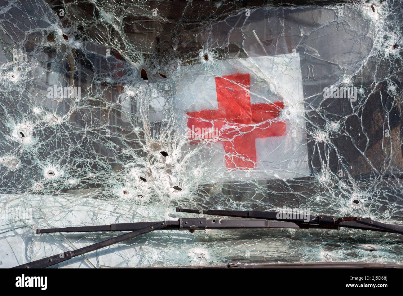 Bus evacuating civilian shooting bullet glass hole shot bullet windshield broken icon red cross sign humanitarian logo. 2022 War Russia invasion Stock Photo