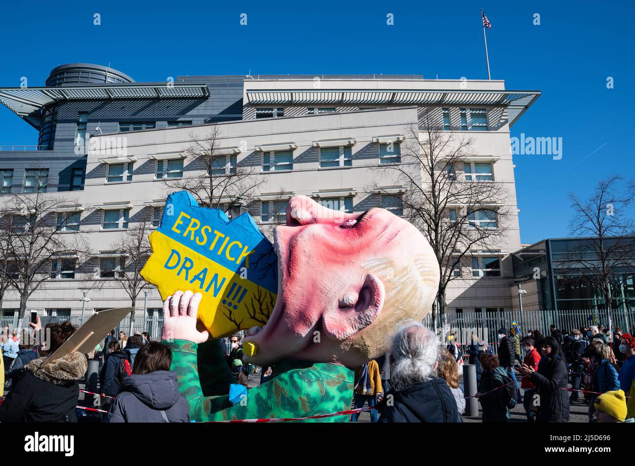 '13.03.2022, Berlin, Germany, Europe - A carnival float by sculptor and float builder Jacques Tilly passes the U.S. Embassy and shows a Vladimir Putin made of papier-mache with the inscription ''Erstick Dran!'' trying to swallow Ukraine. In Berlin, tens of thousands of people again demonstrate for peace in Europe and against Russia's war of aggression in Ukraine. The large demonstration will lead from Alexanderplatz via Potsdamer Platz to the Victory Column and will take place under the motto ''Stop the war! Peace and solidarity for the people of Ukraine''. [automated translation]' Stock Photo