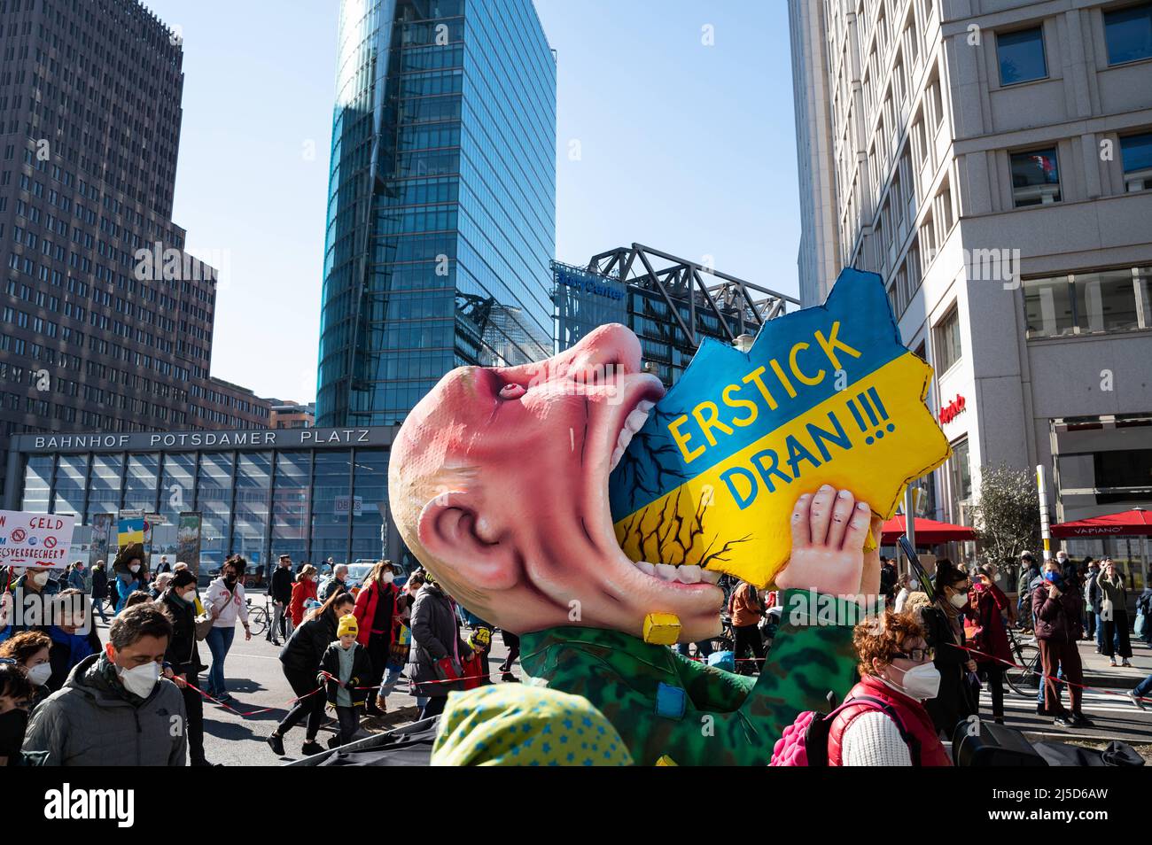 '13.03.2022, Berlin, Germany, Europe - A carnival float by sculptor and float builder Jacques Tilly passes Potsdamer Platz and shows a Vladimir Putin made of papier-mache with the inscription ''Erstick Dran!'' trying to swallow Ukraine. In Berlin, tens of thousands of people again demonstrate for peace in Europe and against Russia's war of aggression in Ukraine. The large demonstration will lead from Alexanderplatz via Potsdamer Platz to the Victory Column and will take place under the motto ''Stop the war! Peace and solidarity for the people of Ukraine''. [automated translation]' Stock Photo