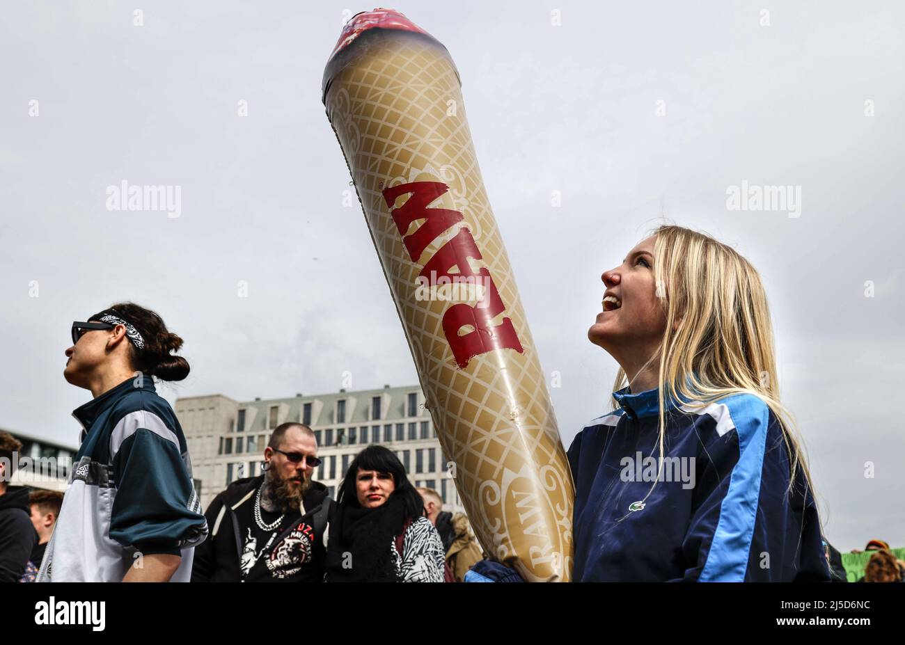 Berlin, April 20, 2020 - A woman holds a model of a giant joint during a demonstration in Berlin on April 20, the worldwide day of action for legal marijuana use. The demonstrators demand legalization and immediate decriminalization of cannabis users in Germany. [automated translation] Stock Photo