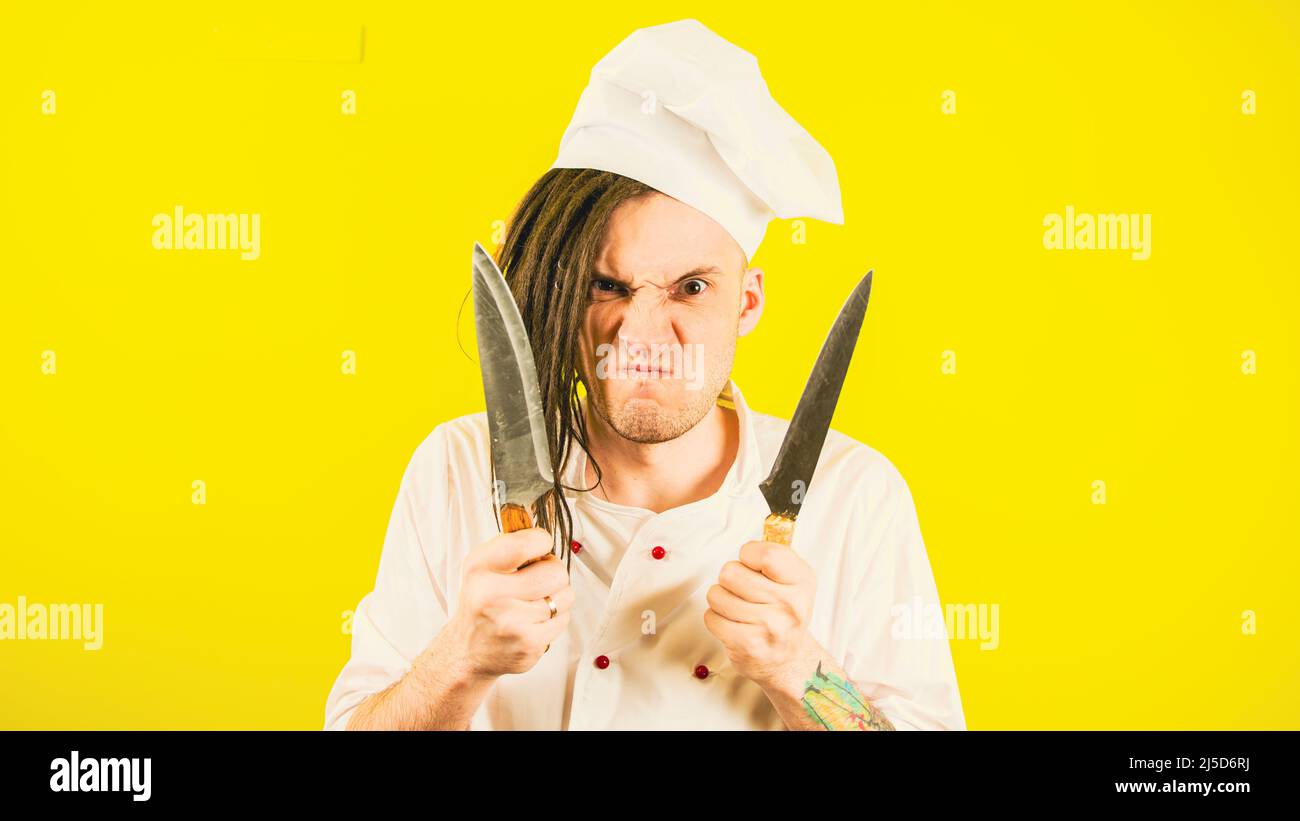 Crazy male cook in white hat and shirt posing with kitchen knives Stock ...