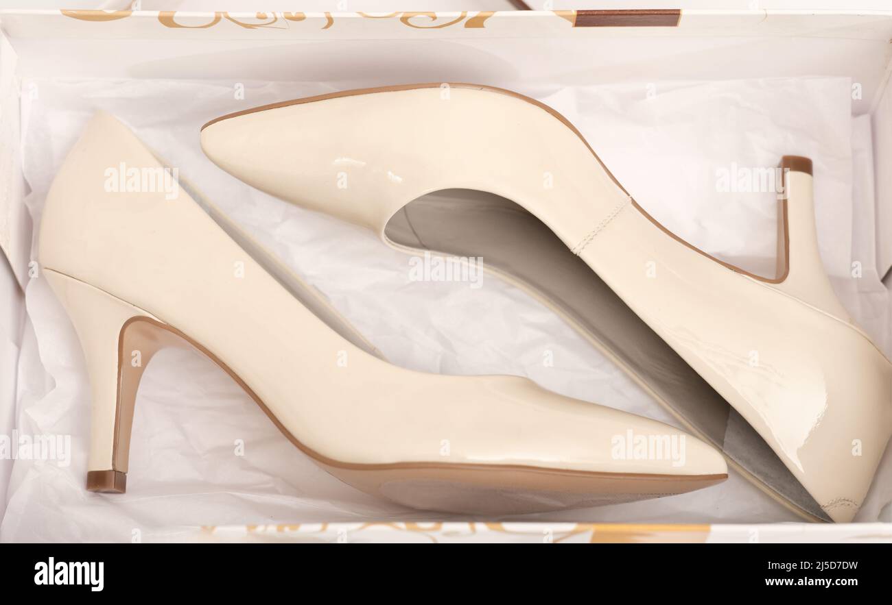 new pair of classic beige heel shoes in a box. shopping, retail and footwear concept Stock Photo