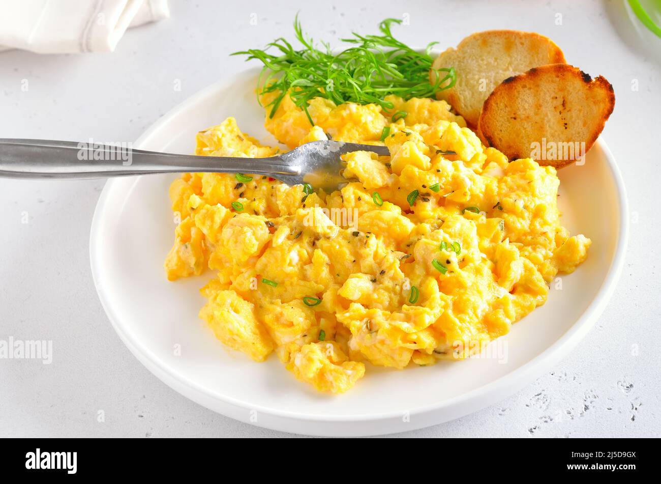 plate of scrambled eggs isolated on white background, top view Stock Photo  - Alamy