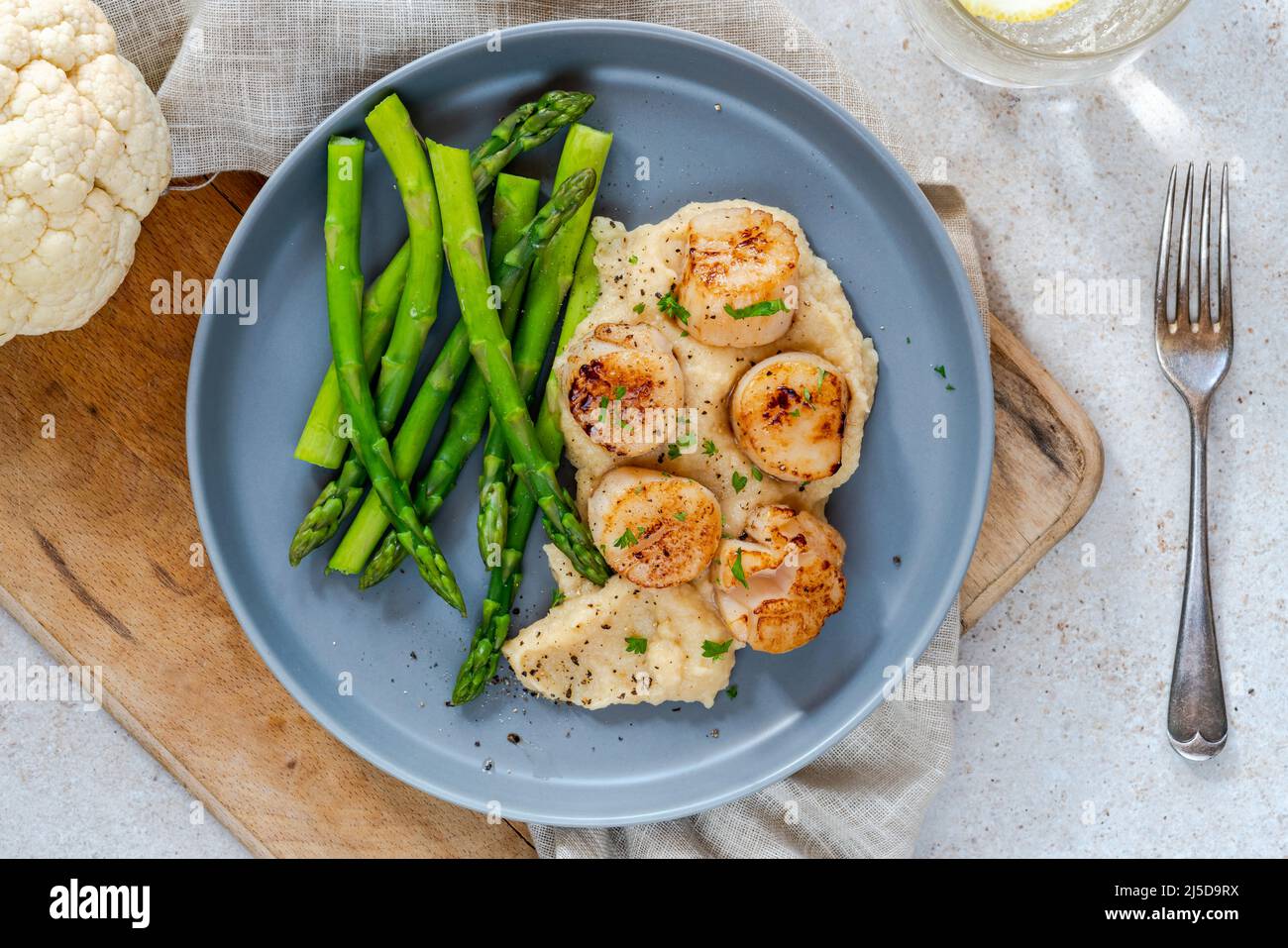 Panfried scallops with cauliflower and bean puree and asparagus Stock Photo Alamy