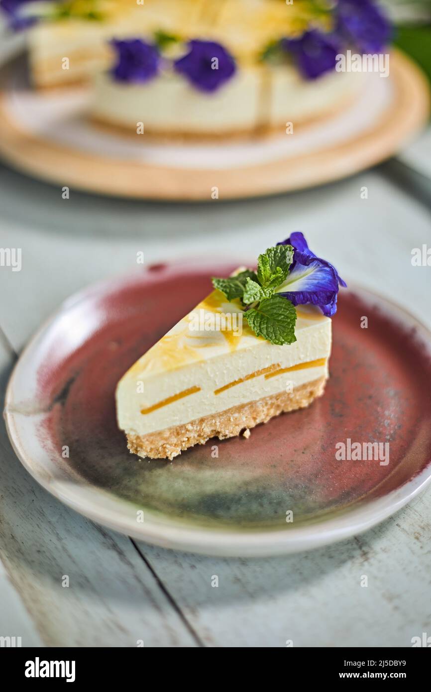 mango cheese cake on wood background,selective focus Stock Photo