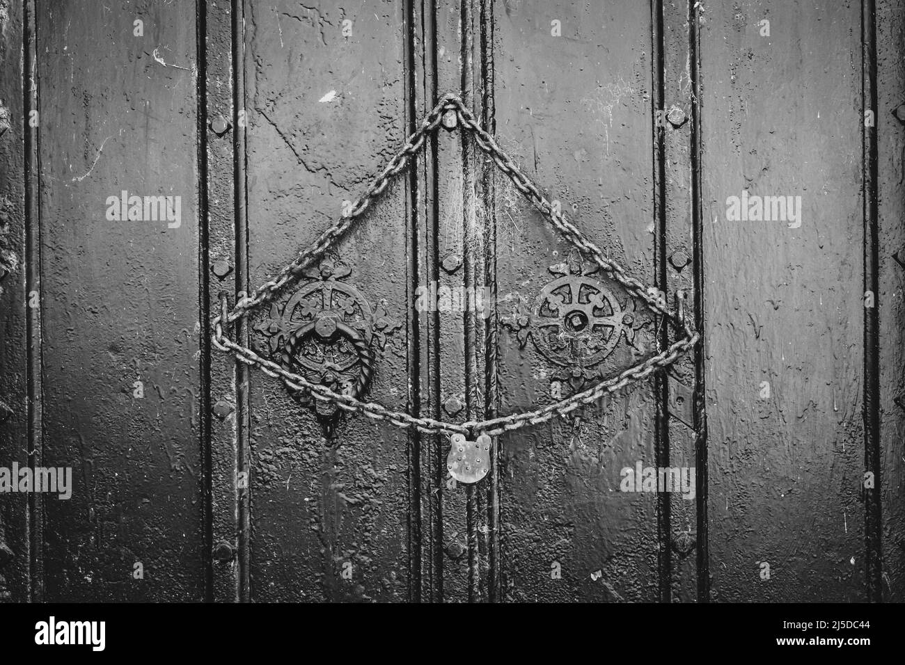 Lock and chain on old wooden vault door Stock Photo